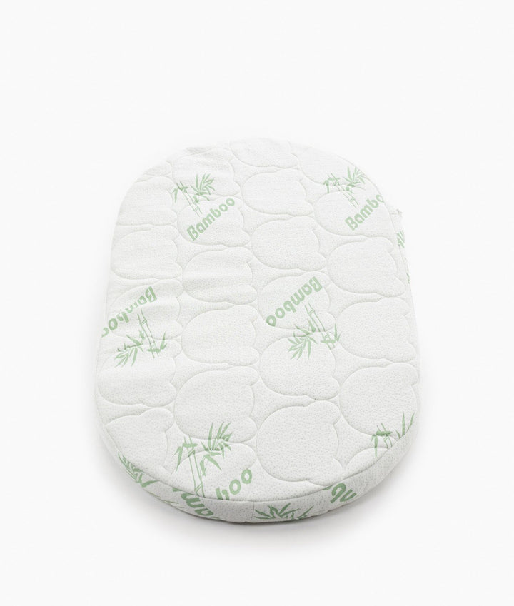 White baby cot with teddy bear design styled in a neutral nursery room
