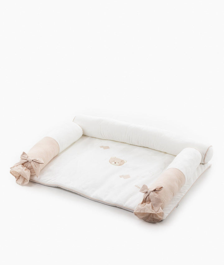 Angled view of 4pc change mat set with white bolsters and beige gingham bows