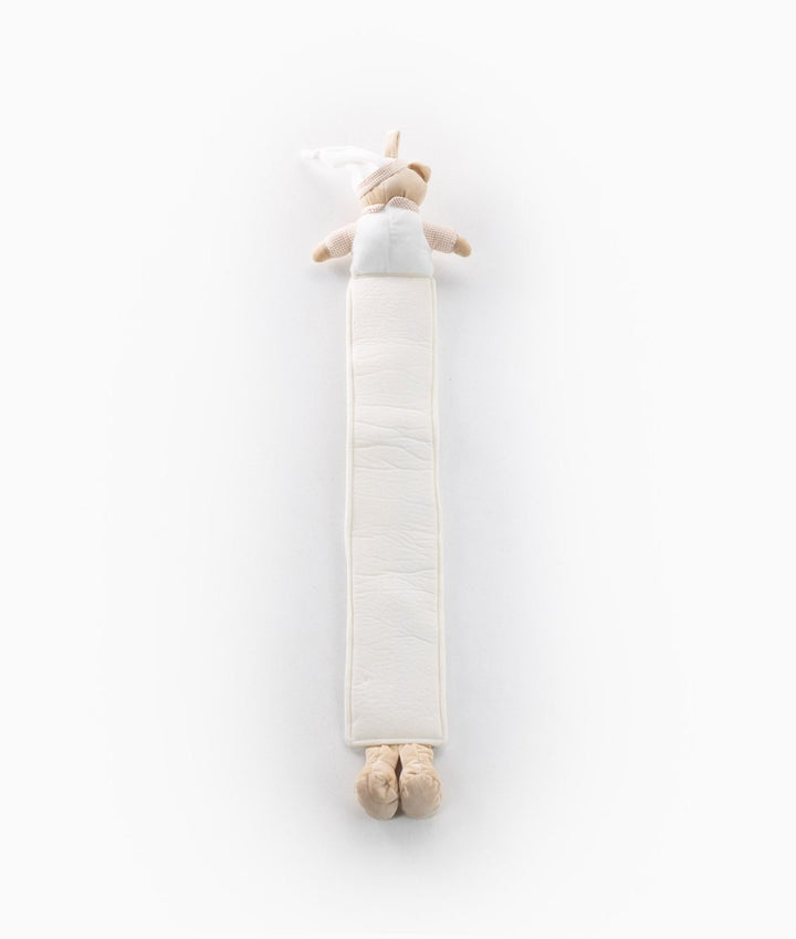 Vertical flat lay of beige and white plush baby growth chart with checkered sleeves and quilted cream body
