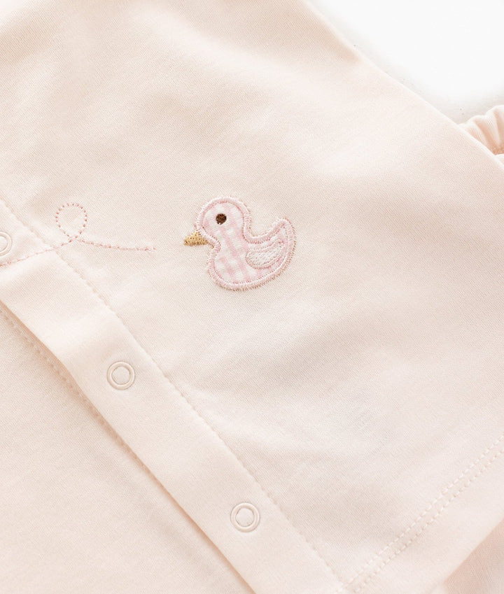 Macro shot of snap button placket with gingham duck embroidery and balloon string detail