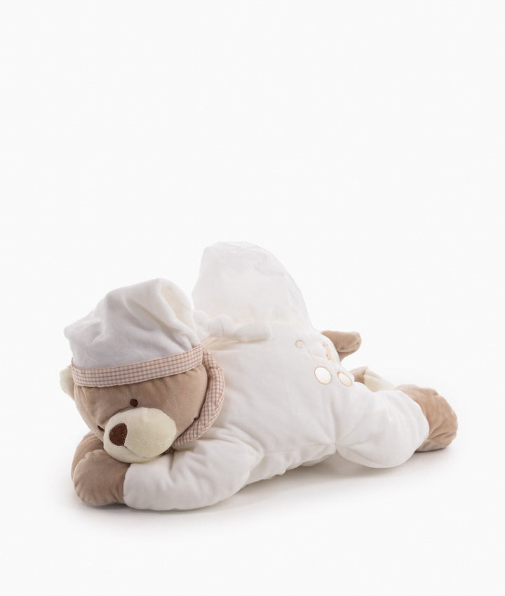 Full side view beige teddy bear wipes holder lying prone with dispensed tissue