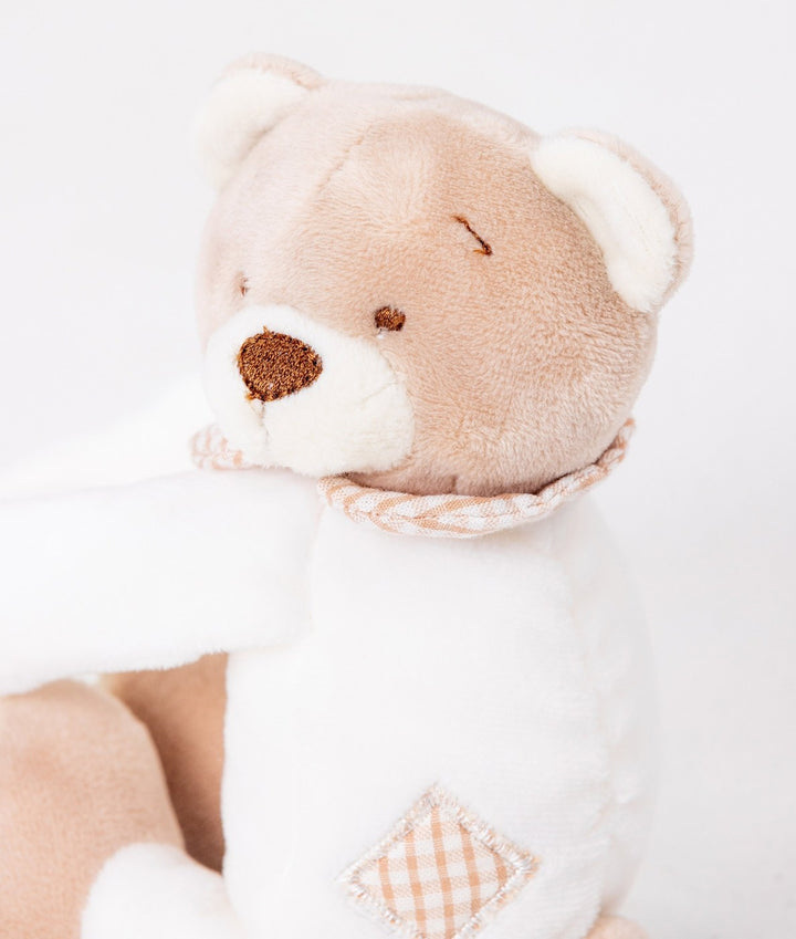 Macro detail of bear curtain tieback head showing embroidered nose, eye stitching, and diamond gingham patch
