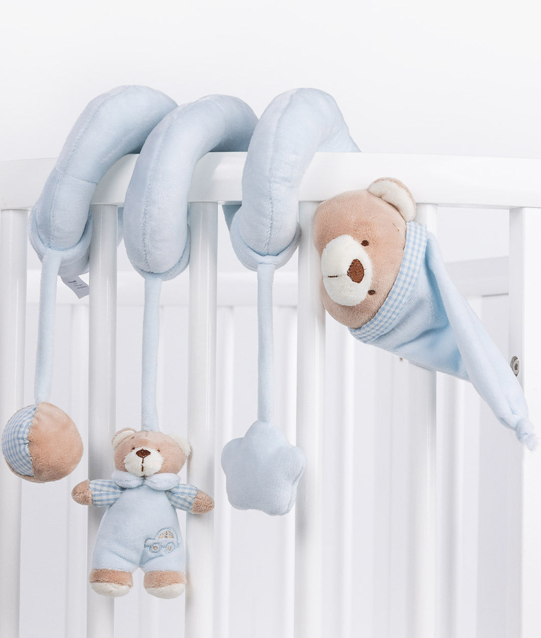 Blue bear spiral toy attached to crib with hanging sensory charms and star detail