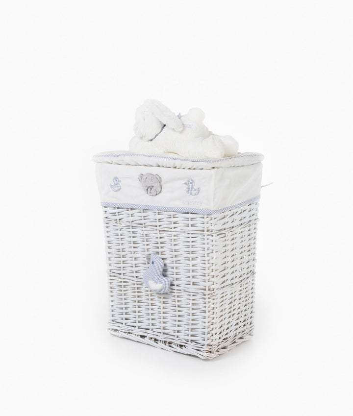 Angled view of white woven storage basket with duck applique, embroidered motifs, and plush bunny lid