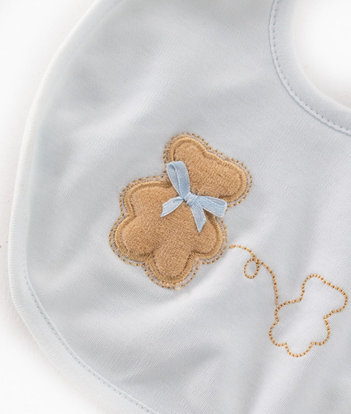 Close-up of soft terry cloth texture and embroidered cloud detail on baby bib