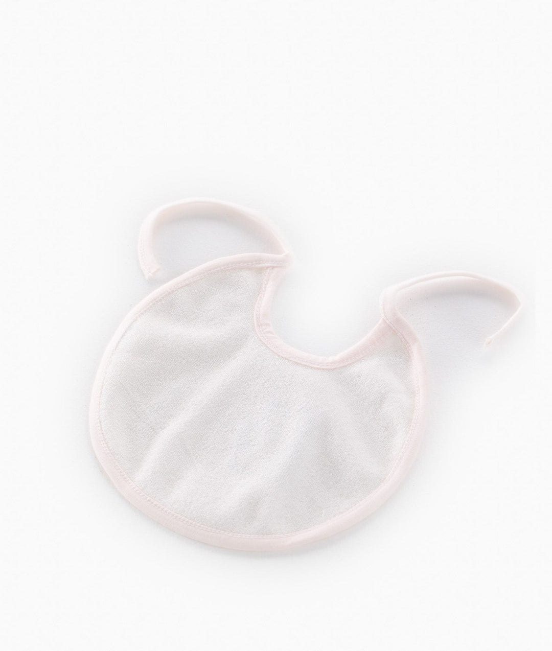 Back view of pink baby bib showing smooth absorbent inner fabric texture and curved neck binding