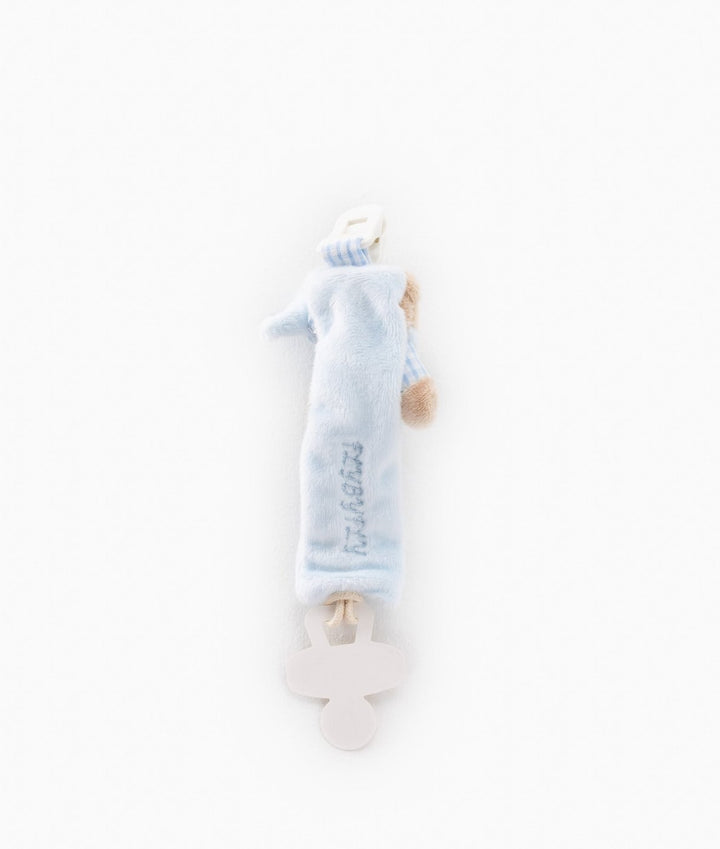Back view of light blue plush dummy clip showing vertical embroidered text on fuzzy material