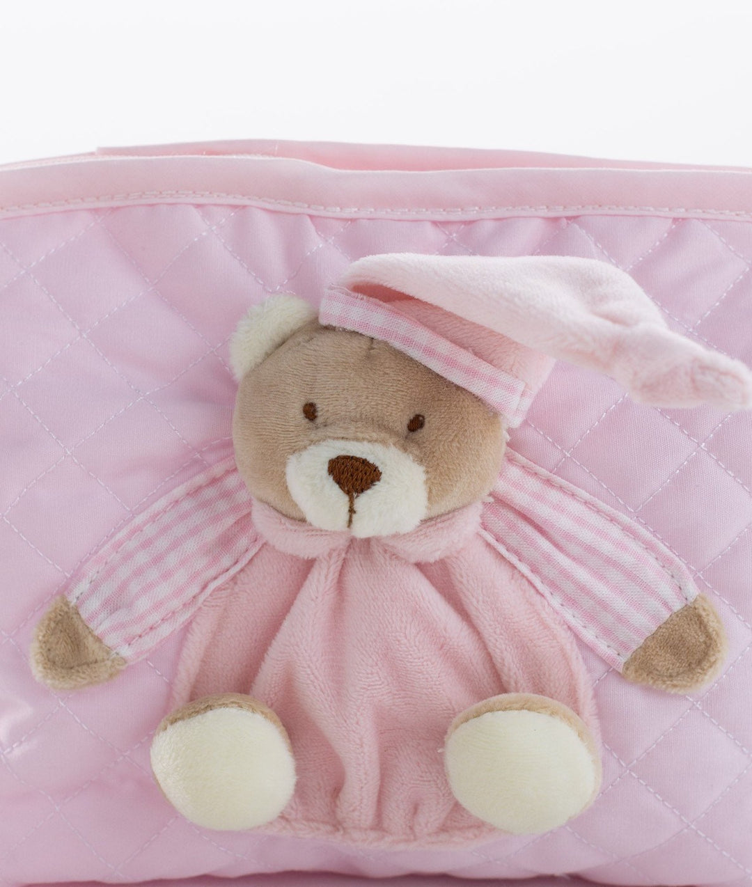 Close up of plush teddy bear embellishment on diamond stitch bag