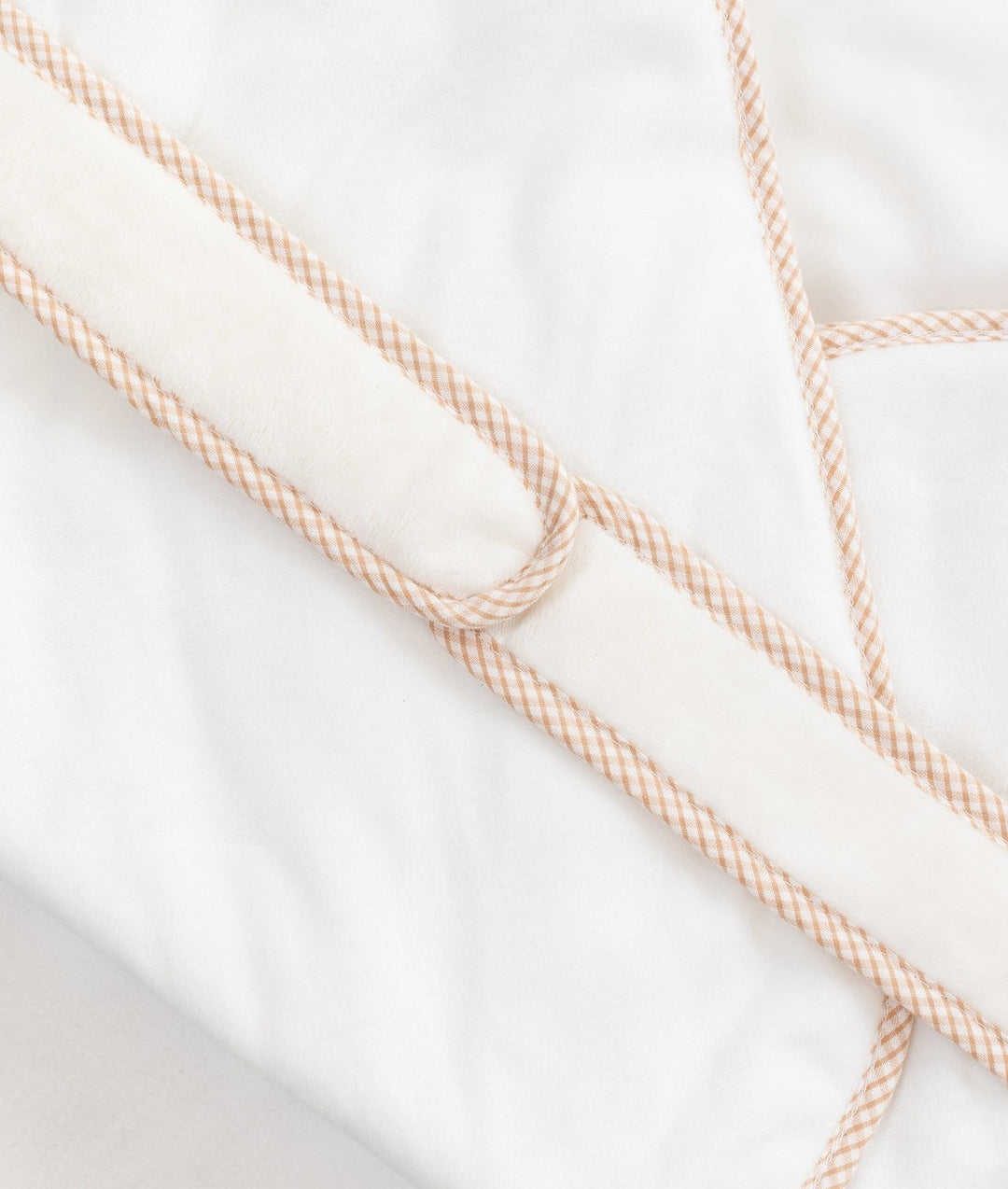 Beige gingham check trim detail on padded tie closure of baby swaddle