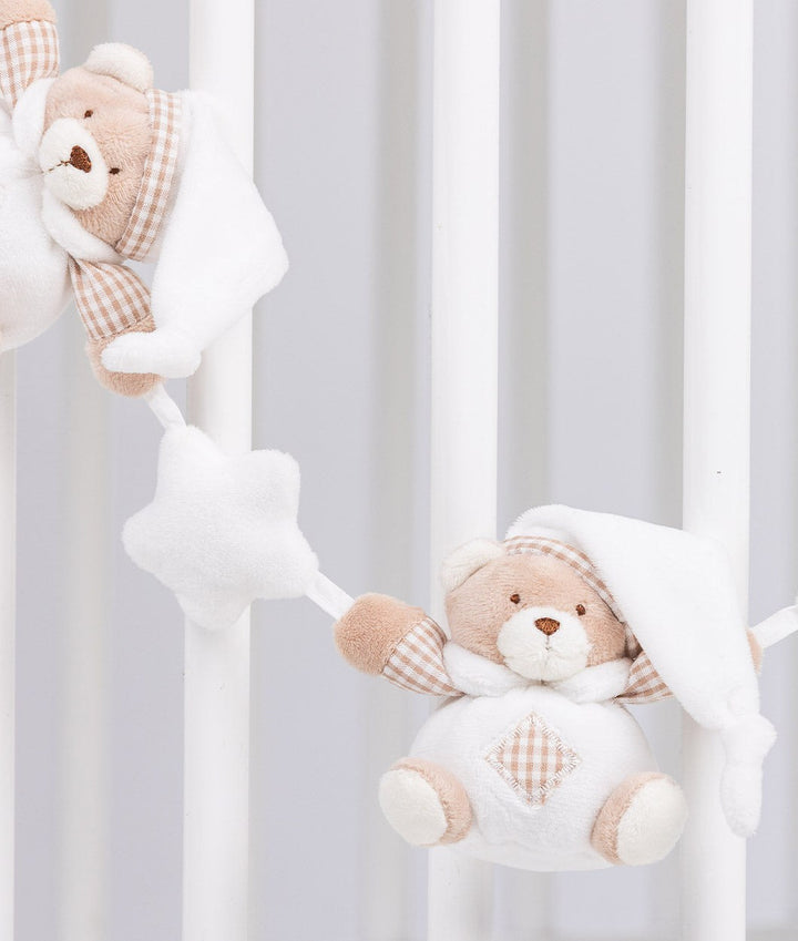 Soft white star connector between bears hanging on crib slats