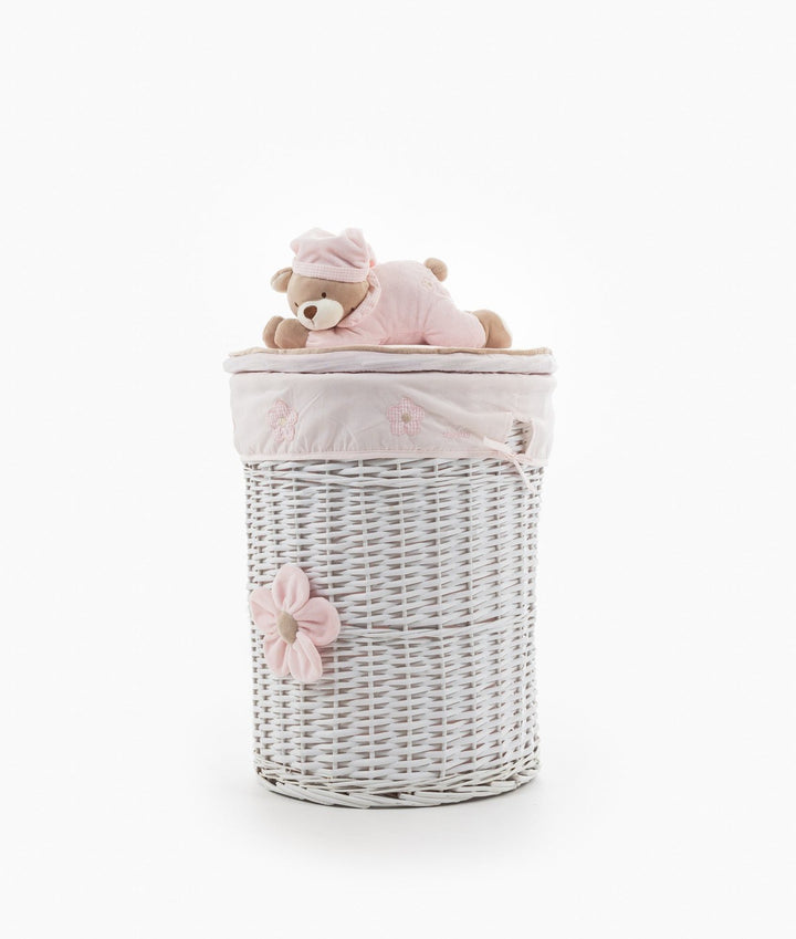 Front view of cylindrical white wicker basket with pink teddy bear lid