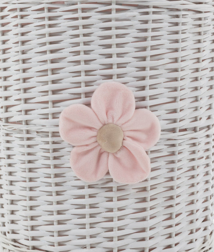 Close-up of white wicker basket texture with pink fabric flower applique