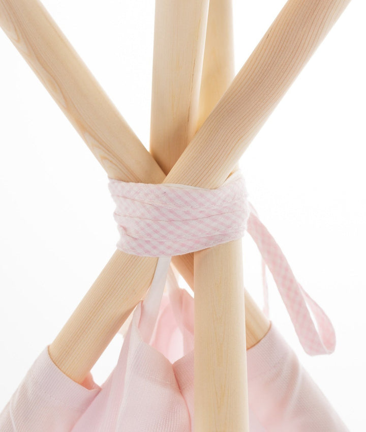 Macro shot of wooden poles wrapped in pink checkered tape at peak