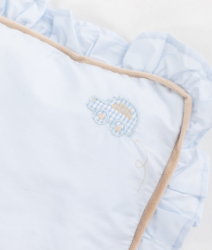 Light blue cotton toddler pillow with embroidered car motif, ruffle border, and piped edge trim