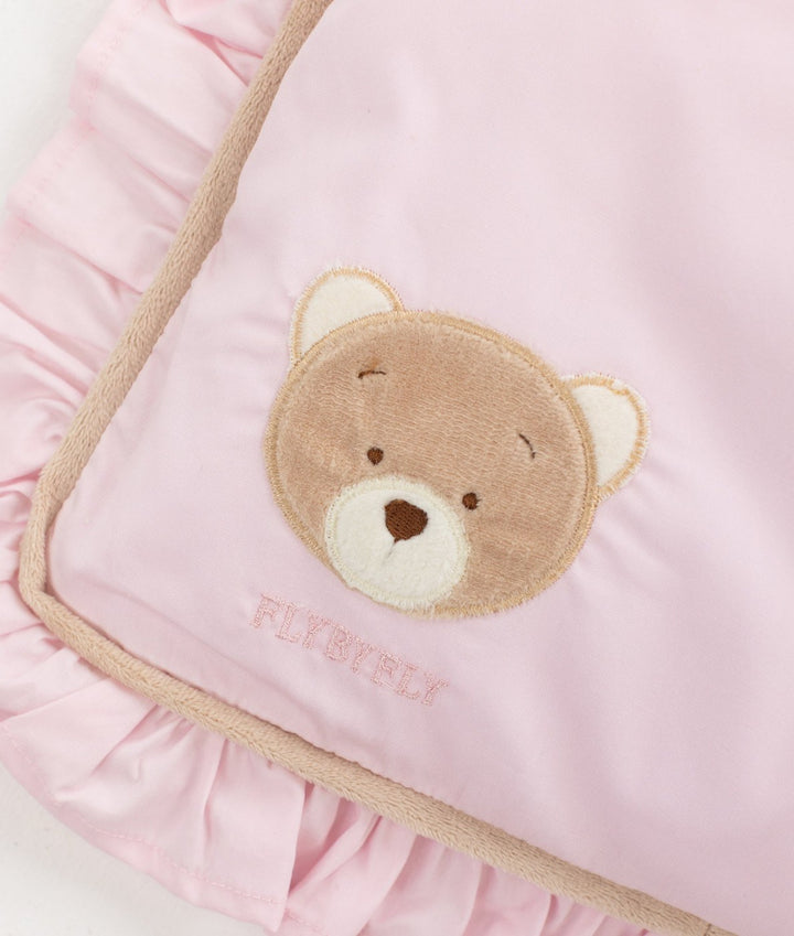 Pink cotton toddler pillow detail with embroidered teddy bear face and beige cord trim
