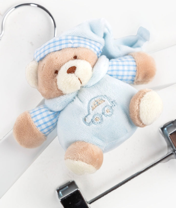 Detail of blue plush teddy bear with gingham hat attached to wooden baby hanger