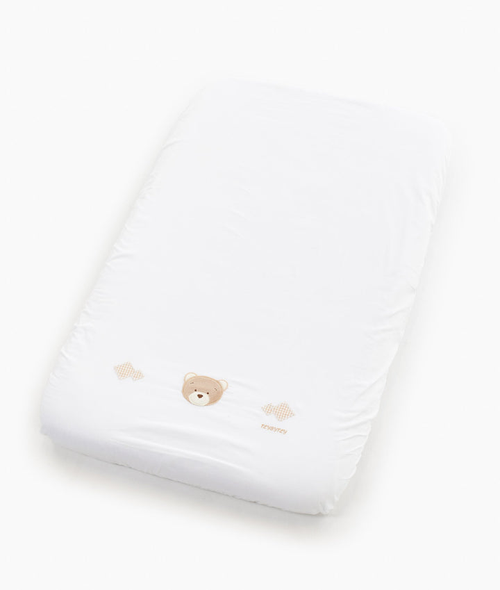 White and beige baby bassinet bedding