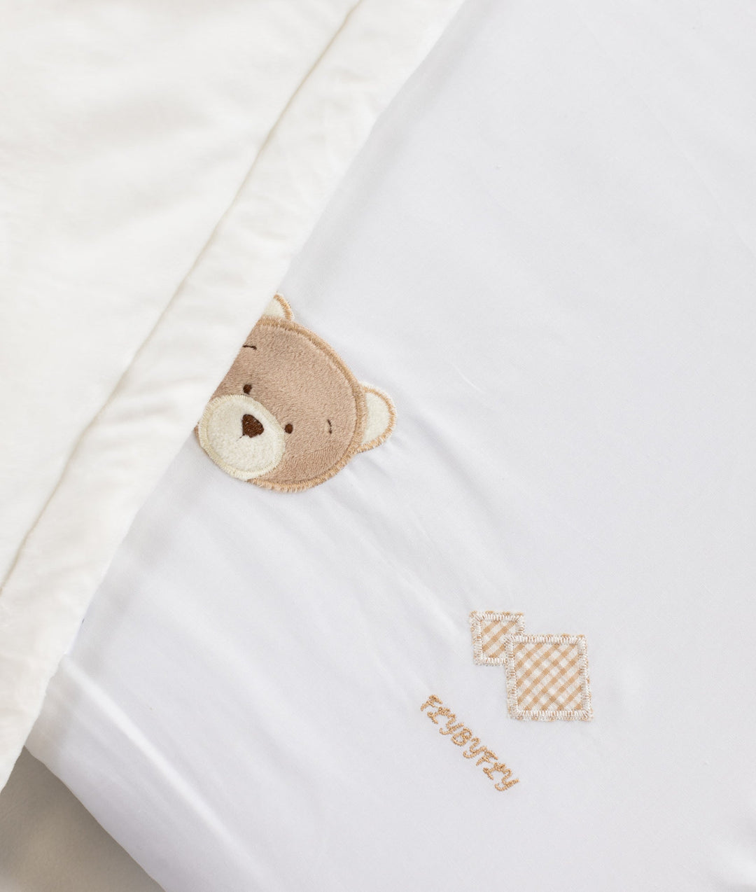 White and beige baby bassinet bedding