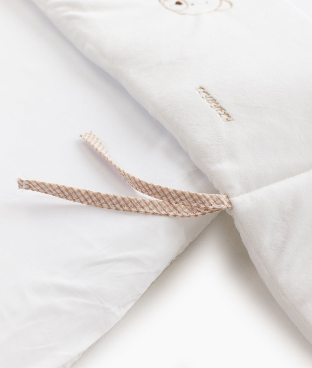 White and beige baby bassinet bedding